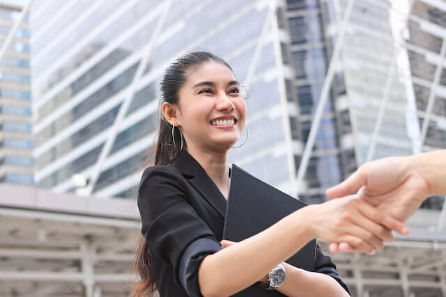 woman having a handshake with her co-worker