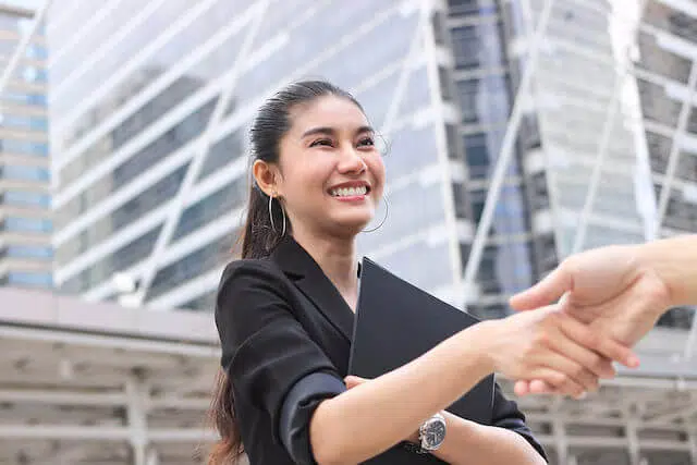 woman having a handshake with her co-worker
